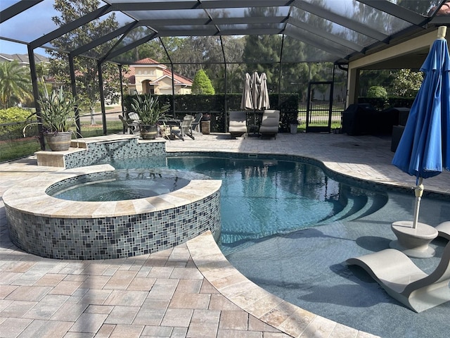 view of swimming pool with a patio area, a pool with connected hot tub, and glass enclosure