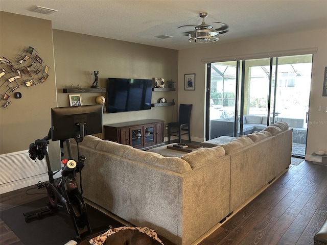 4622 Grand Lakeside Dr, Palm Harbor, FL 34684 - living area with dark wood-style floors, baseboards, and ceiling fan