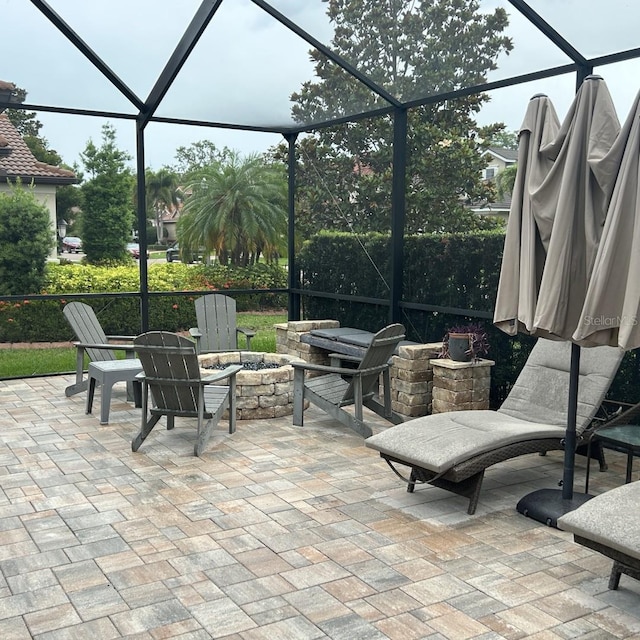 4622 Grand Lakeside Dr, Palm Harbor, FL 34684 - view of patio featuring a lanai and an outdoor fire pit
