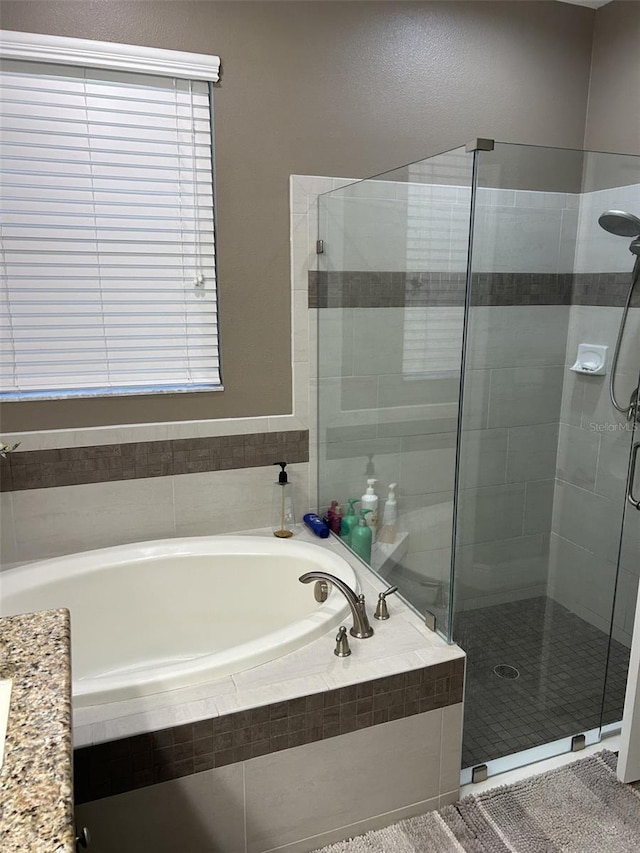 4622 Grand Lakeside Dr, Palm Harbor, FL 34684 - bathroom featuring a garden tub and a shower stall