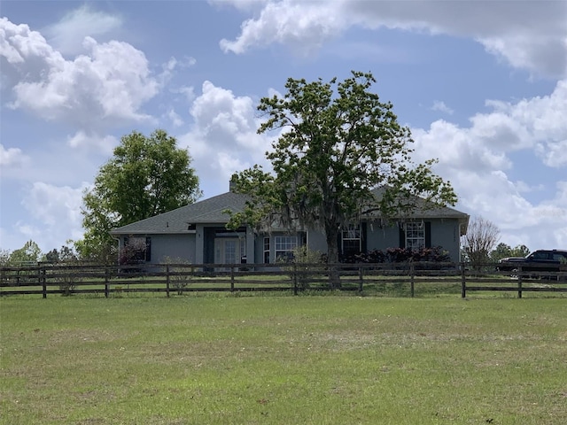 13590 SE 127th Pl, Dunnellon, FL 34431 - view of front of home with fence, a front lawn, and stucco siding