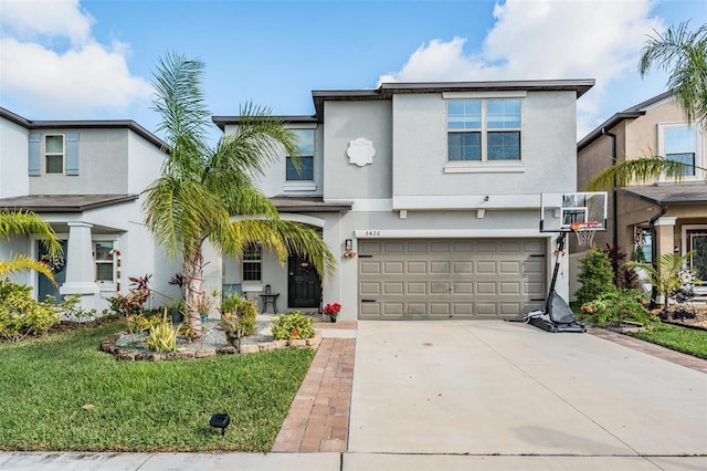 5426 Rainwood Meadows Dr, Apollo Beach, FL 33572 - view of front facade featuring an attached garage, driveway, stucco siding, and a front lawn
