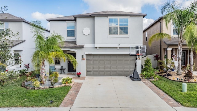 5426 Rainwood Meadows Dr, Apollo Beach, FL 33572 - view of front of home with roof with shingles, concrete driveway, a garage, and stucco siding