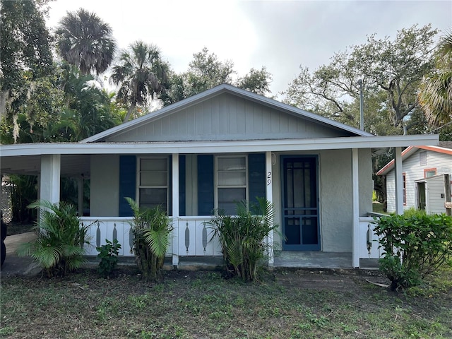 29 Michiana Dr, Terra Ceia, FL 34250 - bungalow-style house with covered porch and stucco siding