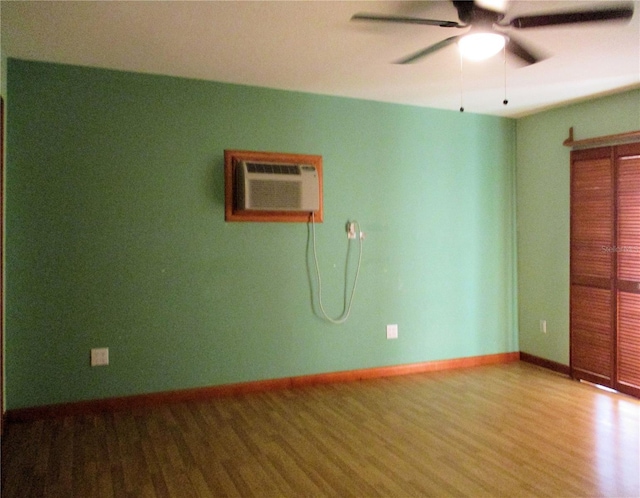 6339 Pontiac Ln, North Port, FL 34287 - unfurnished room with wood finished floors, ceiling fan, and a wall mounted air conditioner