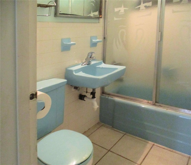 6339 Pontiac Ln, North Port, FL 34287 - bathroom featuring tub / shower combination, tile walls, and tile patterned flooring