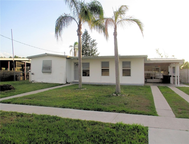 6339 Pontiac Ln, North Port, FL 34287 - ranch-style home featuring a carport, stucco siding, and a front yard