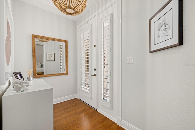 entrance foyer featuring wood finished floors and baseboards