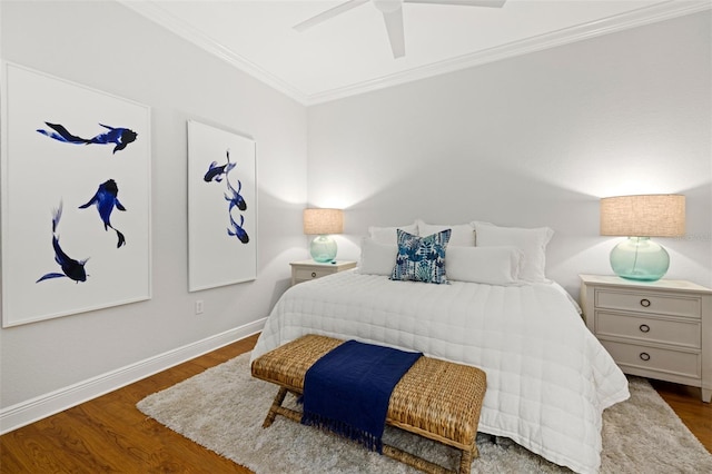 bedroom with ornamental molding, baseboards, ceiling fan, and wood finished floors