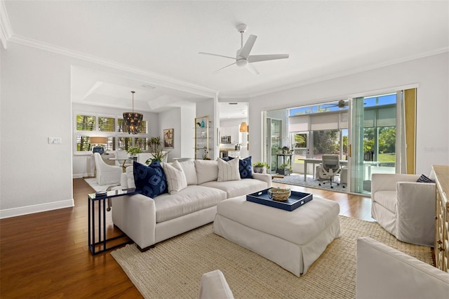 living area featuring crown molding, baseboards, wood finished floors, and ceiling fan with notable chandelier