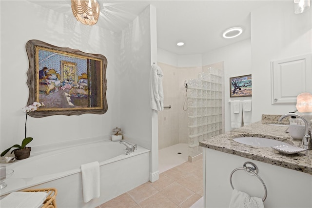 bathroom with a bath, tile patterned flooring, a sink, walk in shower, and double vanity