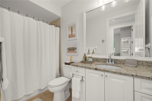 bathroom with tile patterned floors, vanity, and toilet