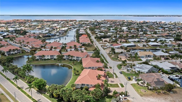 drone / aerial view featuring a water view and a residential view