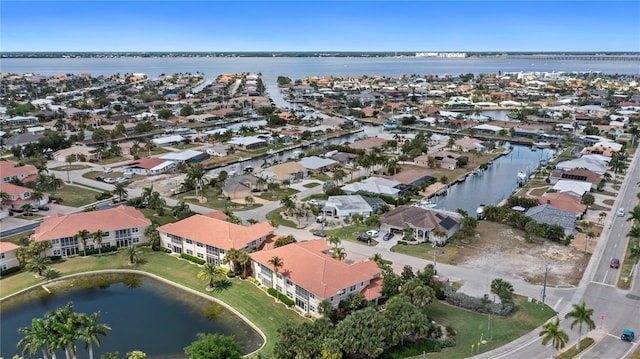 birds eye view of property featuring a residential view and a water view