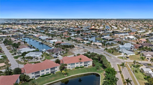 birds eye view of property with a residential view and a water view