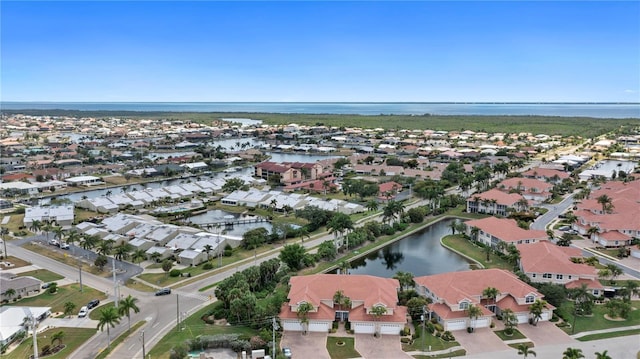 birds eye view of property featuring a water view and a residential view