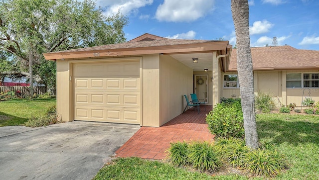 view of front of property featuring a garage, a front yard, and fence