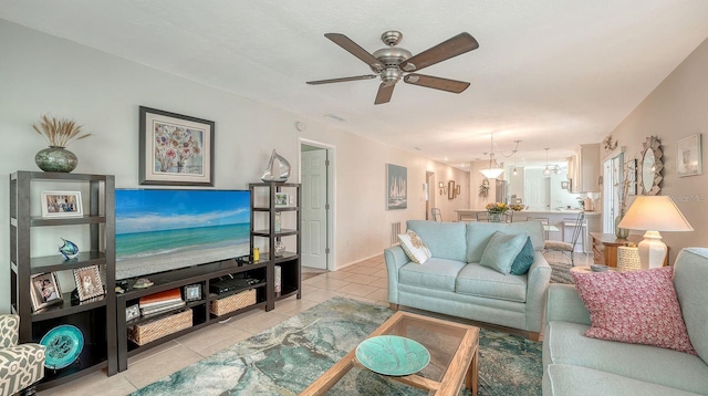 living room with light tile patterned floors, visible vents, and ceiling fan
