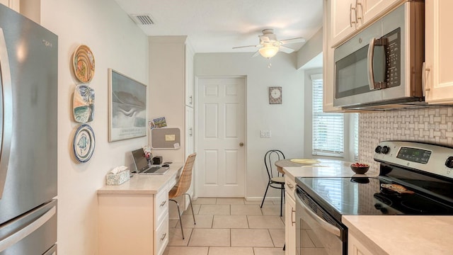 kitchen with ceiling fan, light tile patterned floors, tasteful backsplash, appliances with stainless steel finishes, and light countertops