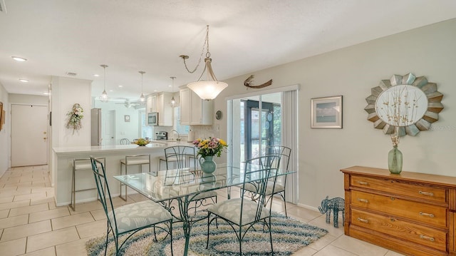 dining room featuring baseboards, a ceiling fan, light tile patterned flooring, and recessed lighting