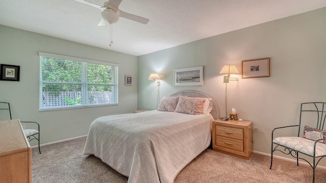bedroom featuring baseboards, a ceiling fan, and light carpet