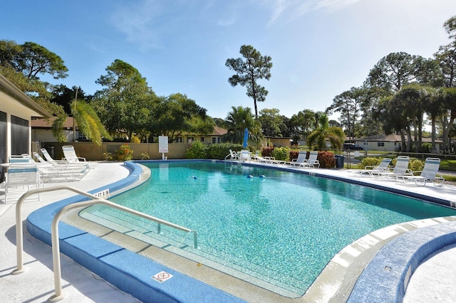 pool featuring fence and a patio