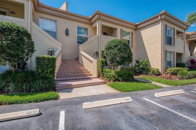 exterior space featuring uncovered parking and stucco siding