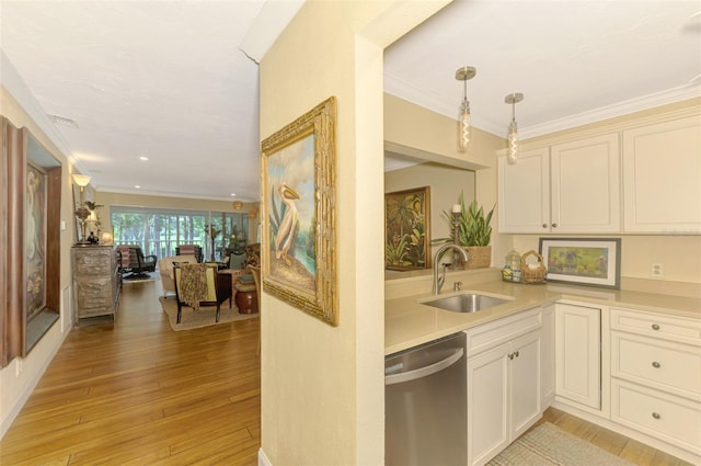 kitchen with ornamental molding, light wood-style flooring, light countertops, stainless steel dishwasher, and a sink