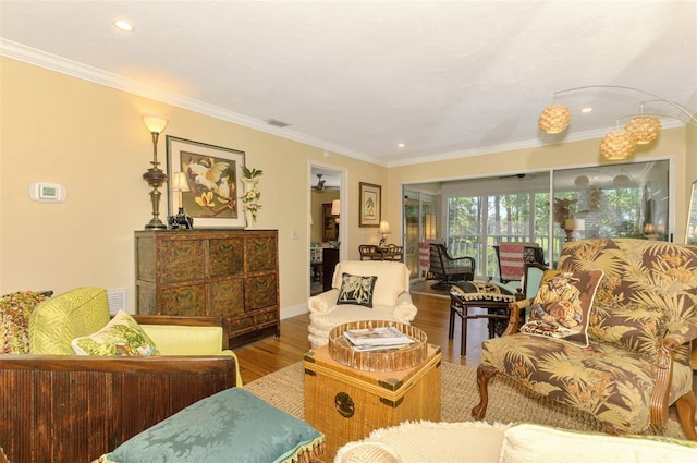 living room with crown molding, baseboards, recessed lighting, and wood finished floors