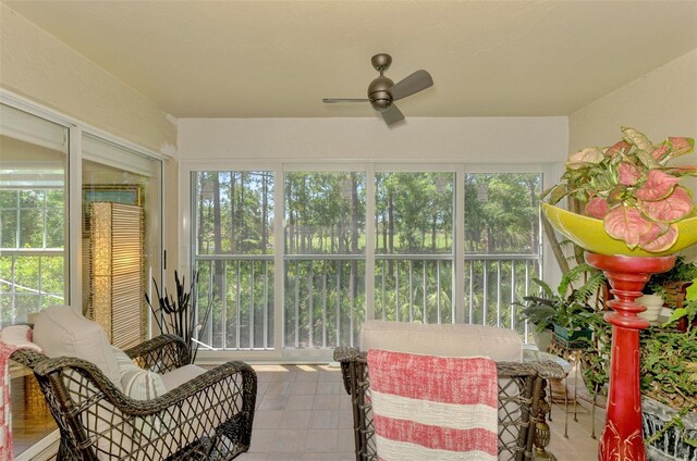 sunroom featuring ceiling fan and a wealth of natural light