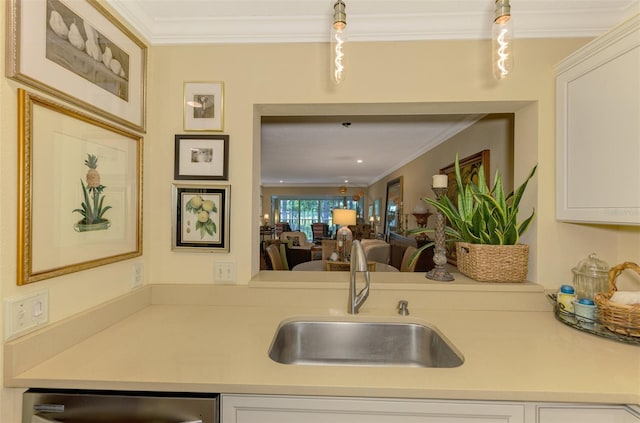 kitchen featuring light countertops, crown molding, stainless steel dishwasher, and a sink