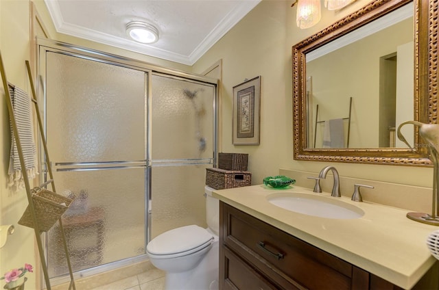full bathroom with crown molding, vanity, tile patterned flooring, toilet, and a stall shower