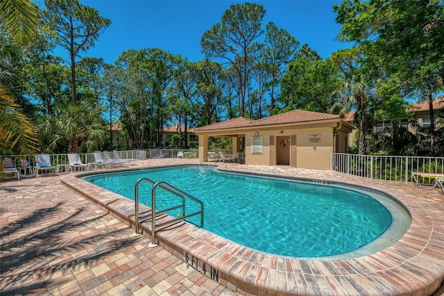 pool featuring a patio area and fence