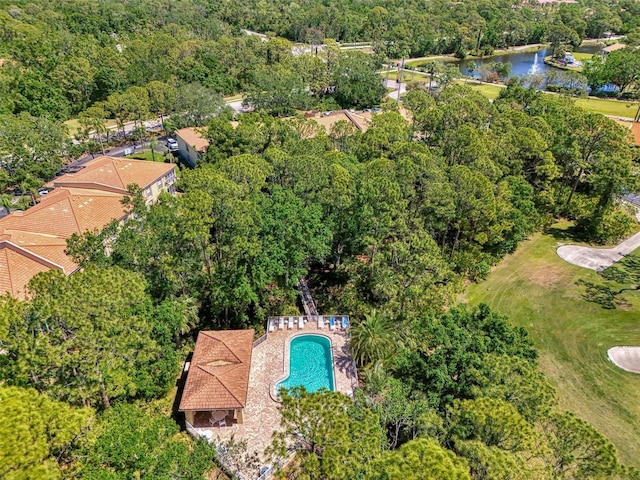drone / aerial view with a water view and a wooded view