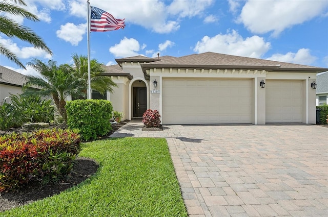 view of front facade with roof with shingles, decorative driveway, a garage, and stucco siding