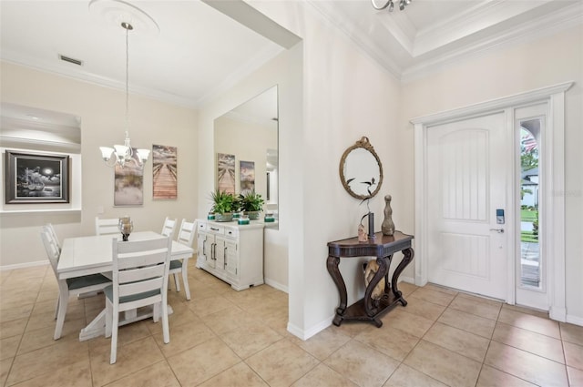 foyer featuring baseboards, a chandelier, light tile patterned floors, crown molding, and visible vents