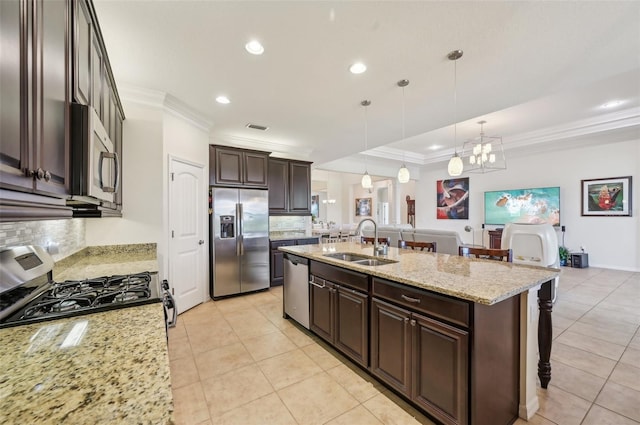 kitchen featuring a notable chandelier, a sink, appliances with stainless steel finishes, dark brown cabinets, and crown molding