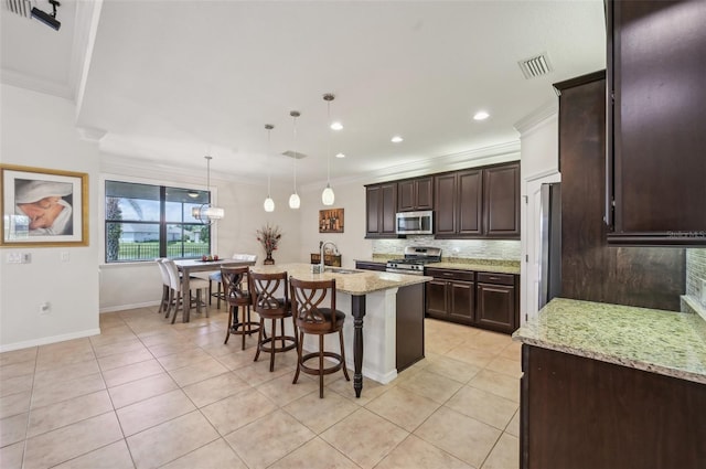 kitchen featuring stainless steel appliances, visible vents, a sink, and crown molding