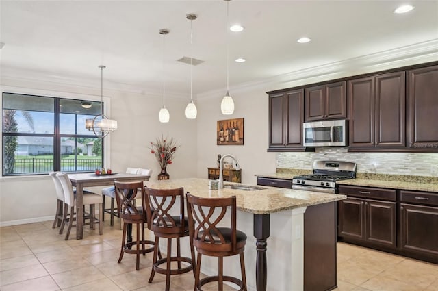 kitchen featuring tasteful backsplash, a sink, ornamental molding, and appliances with stainless steel finishes