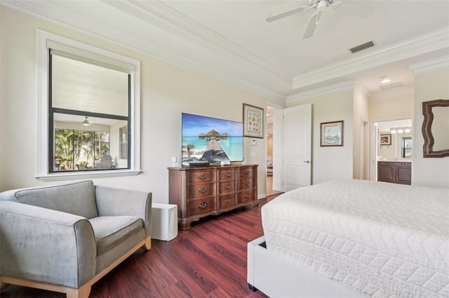 bedroom with crown molding, dark wood finished floors, ensuite bath, a ceiling fan, and visible vents