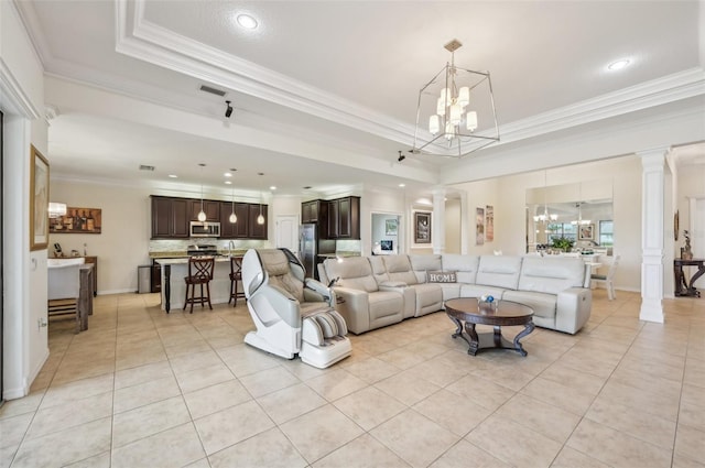 living room with visible vents, a raised ceiling, a chandelier, and light tile patterned flooring