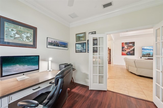 office space with french doors, visible vents, crown molding, and wood finished floors