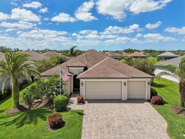 view of front facade with roof with shingles, stucco siding, decorative driveway, and an attached garage