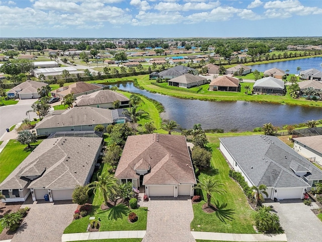 birds eye view of property with a residential view and a water view
