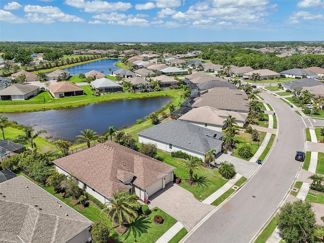 drone / aerial view with a water view and a residential view