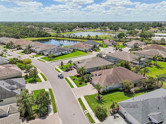 drone / aerial view with a water view and a residential view