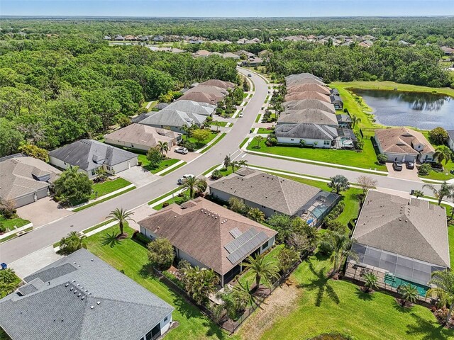 drone / aerial view with a residential view and a water view