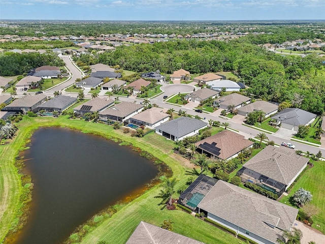 birds eye view of property with a water view and a residential view