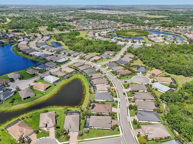 birds eye view of property featuring a water view and a residential view