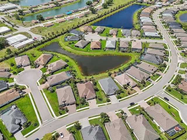 birds eye view of property featuring a water view and a residential view